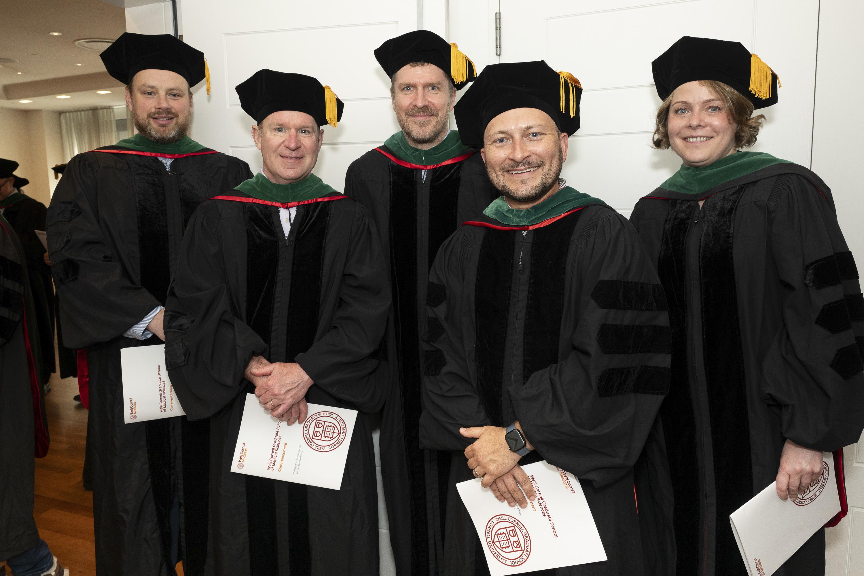 A selection of faculty in their commencement regalia, including Drs. David Nowak, David Rickman, Lukas Dow, Nicholas Brady, and Elena Piskanova